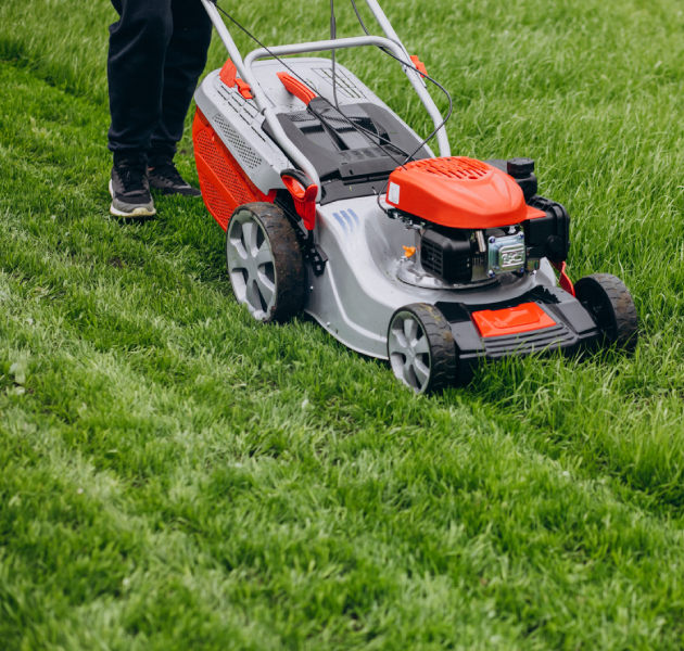 Man cutting grass with lawn mover in the back yard (1) Man cutting grass with lawn mover in the back yard<br />